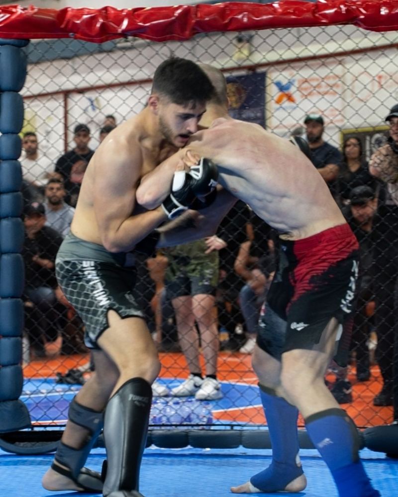 Miliadis Nikos (Μηλιάδης Νίκος), Greek MMA fighter, clinching against an opponent in the cage