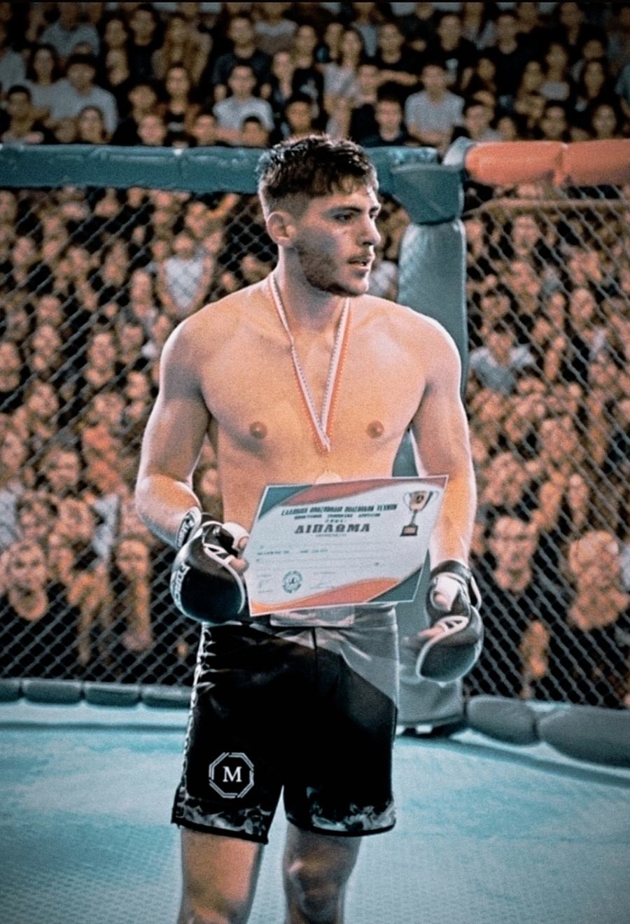 Miliadis Nikos (Μηλιάδης Νίκος), Greek middleweight MMA fighter, wearing a medal and holding a diploma