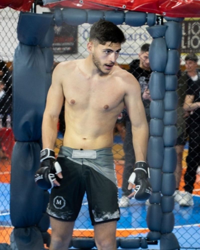 Miliadis Nikos (Μηλιάδης Νίκος), Greek MMA fighter, standing in the cage with gloves on